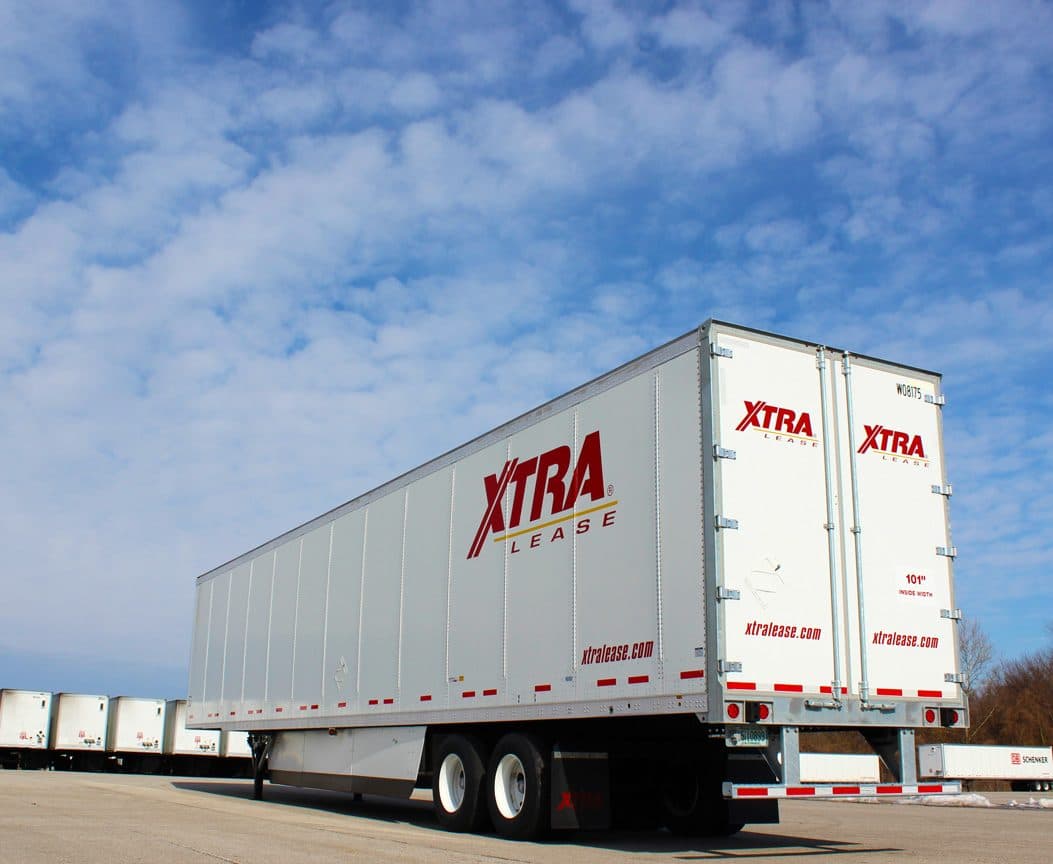 White XTRA Lease 53-foot dry van trailer parked in a row of rental trailers