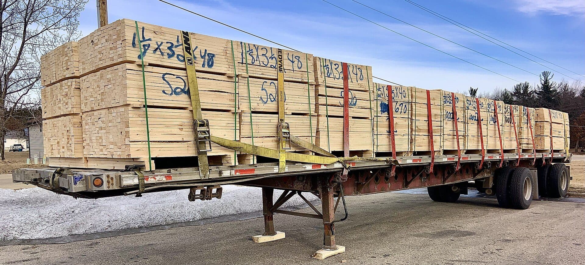 Flatbed trailer loaded with strapped wooden crates
